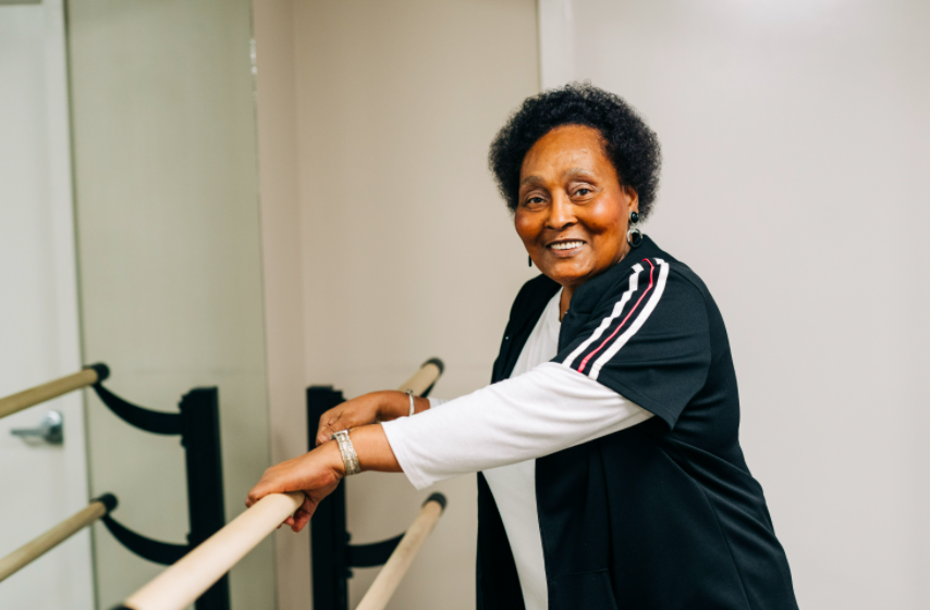 Woman holding onto rail smiling